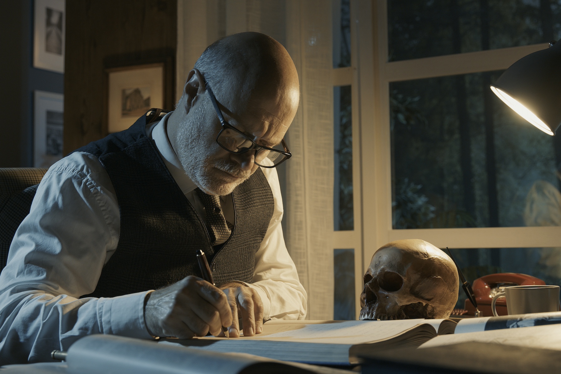 Academic professor studying a human skull